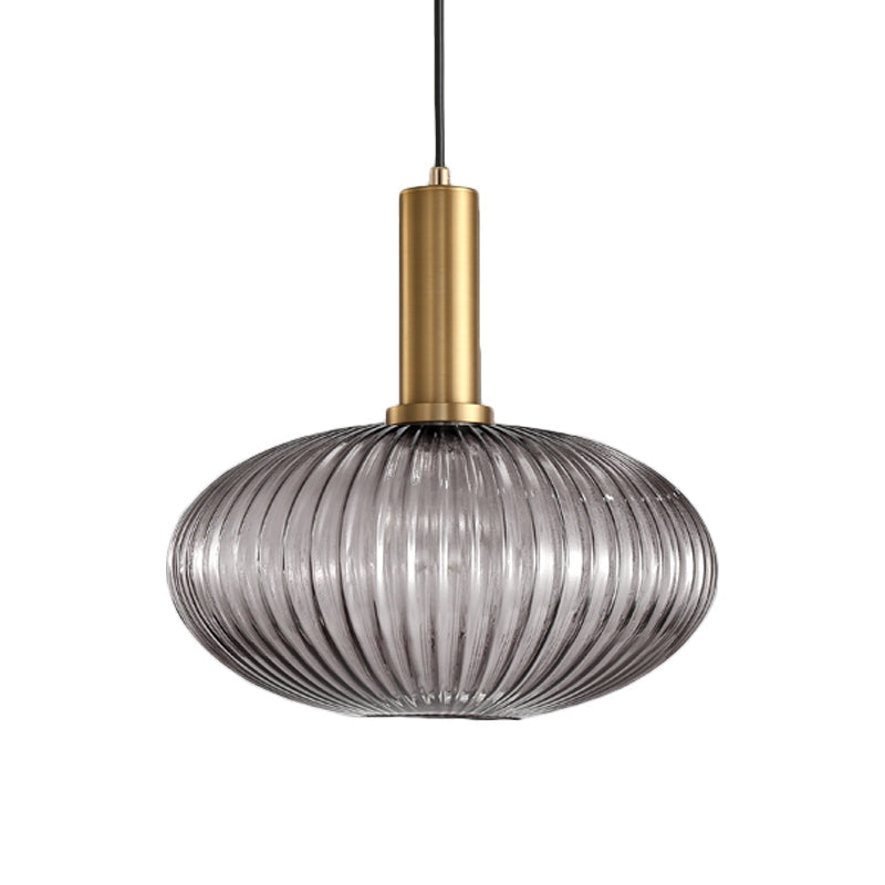 Smoke ribbed oval pendant with a brass collar, shown on white