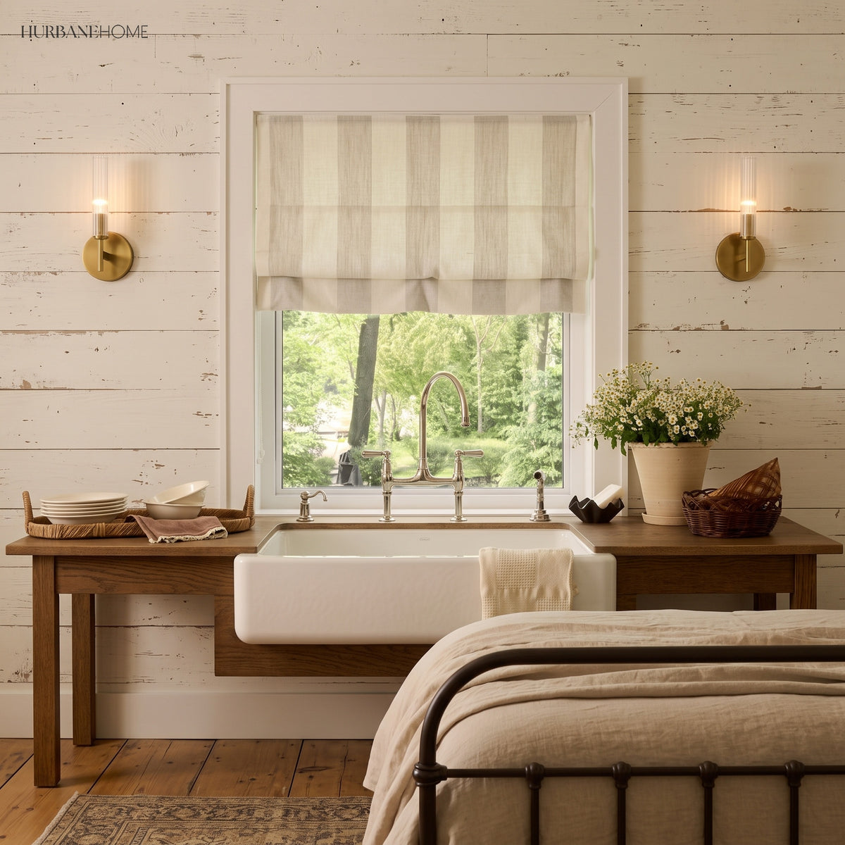 Brass tube sconce lighting a striped roman blind above a farmhouse sink