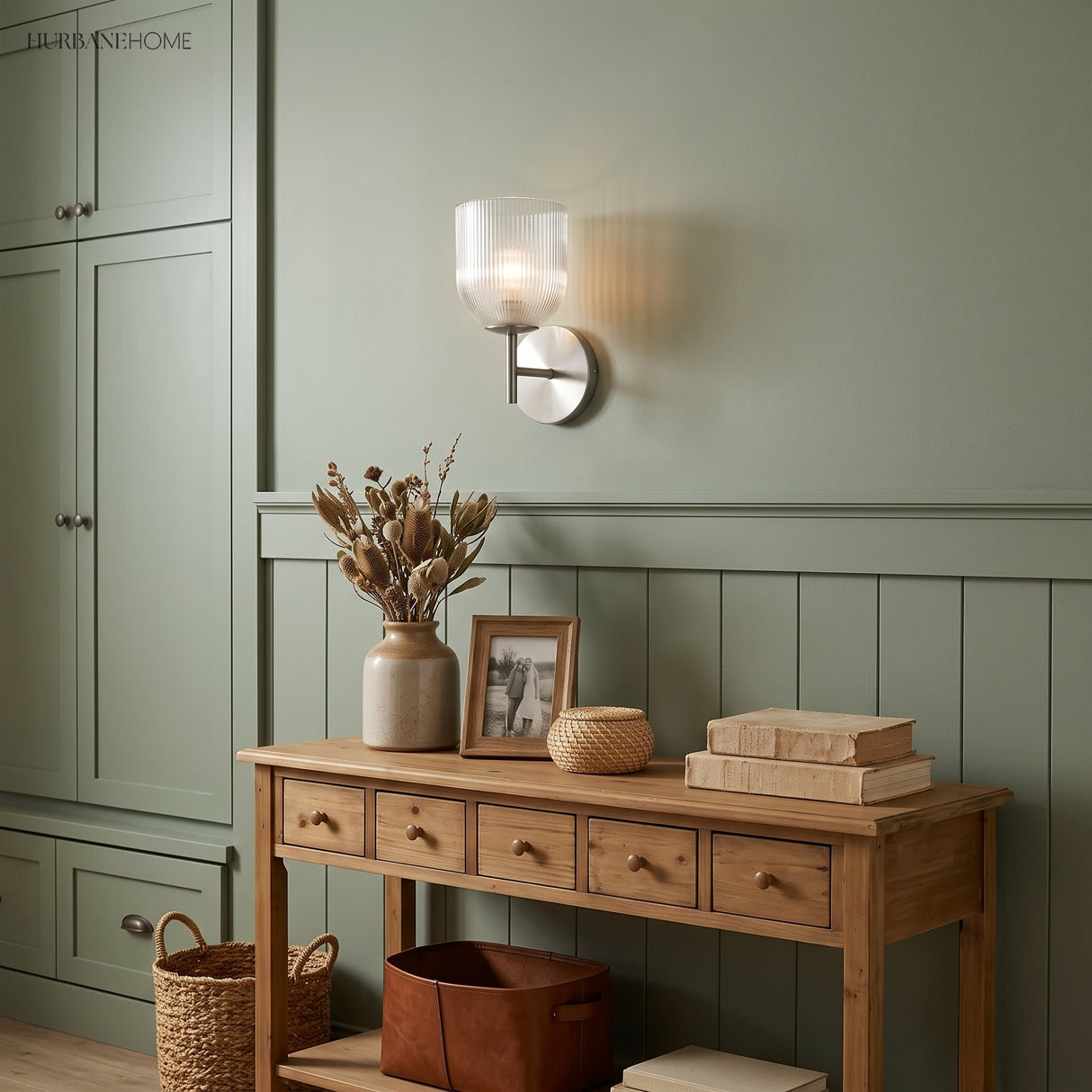 Two brass sconces flanking a framed mirror over a timber vanity