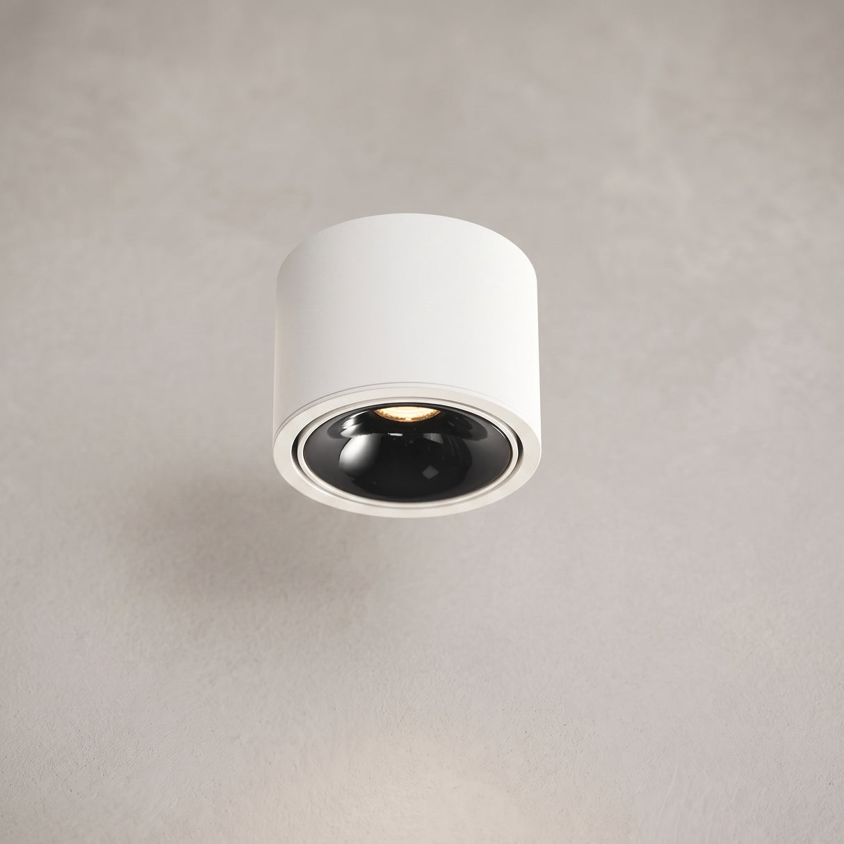 Round adjustable LED surface mount spotlight, studio product photo