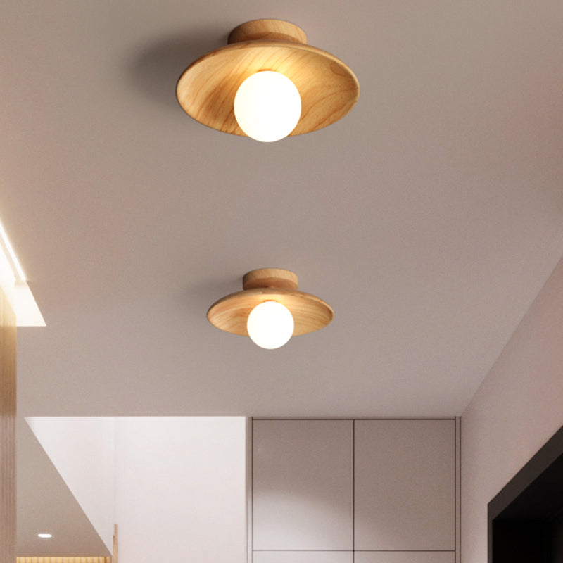 Two wood ceiling lights above a white stairwell and landing