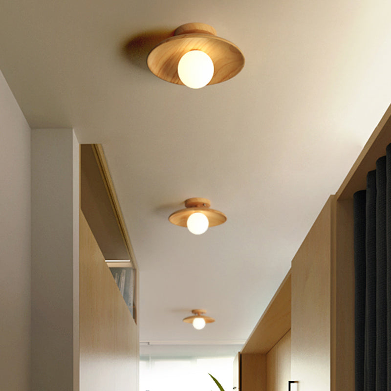 Wood ceiling lights lit along a hallway with a stepped ceiling
