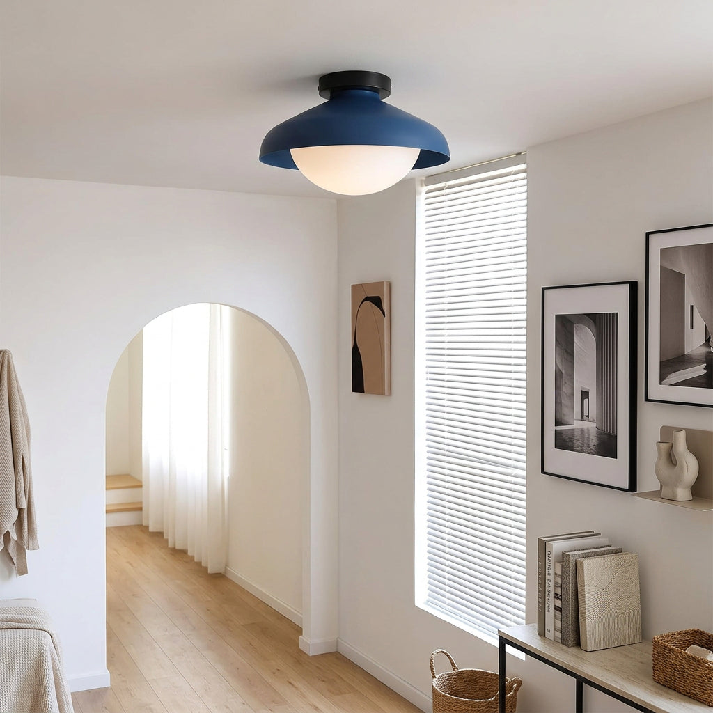 Blue dome ceiling light above an arched doorway in a white hallway
