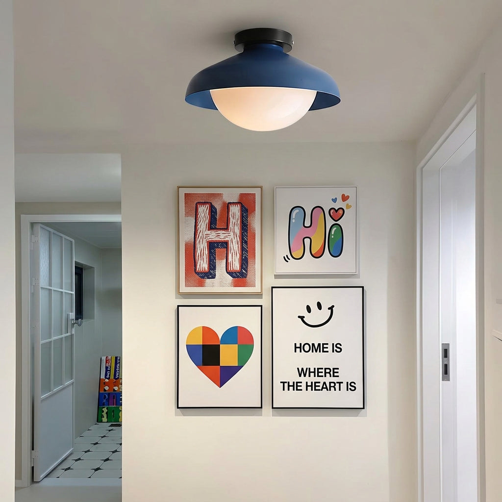 Blue dome ceiling light in a hallway with children's posters on a white wall