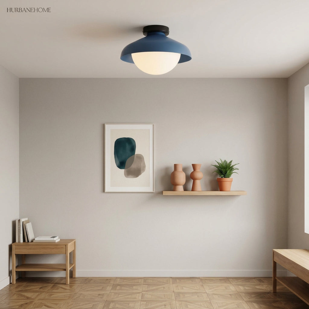 Blue dome ceiling light on a white ceiling above framed art and potted plants