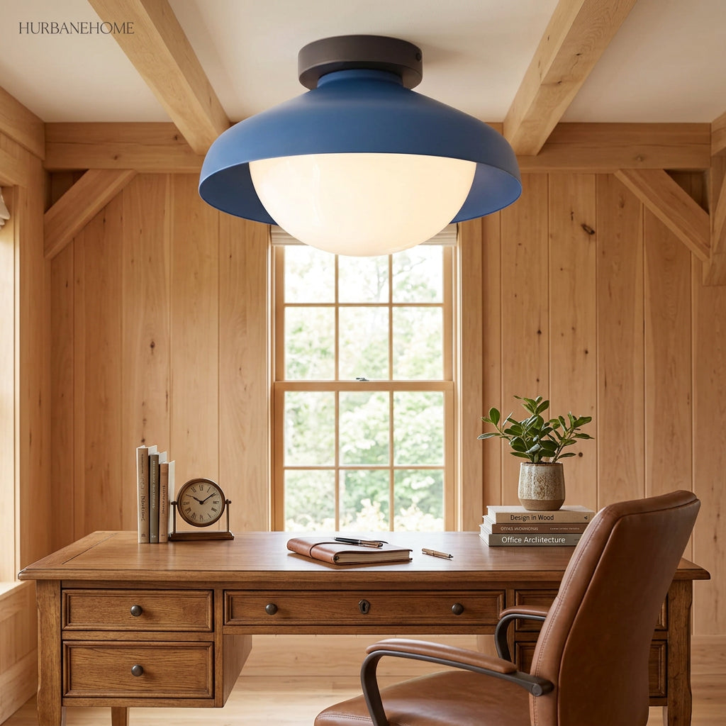 Blue dome ceiling light in a wood panelled home office above a writing desk