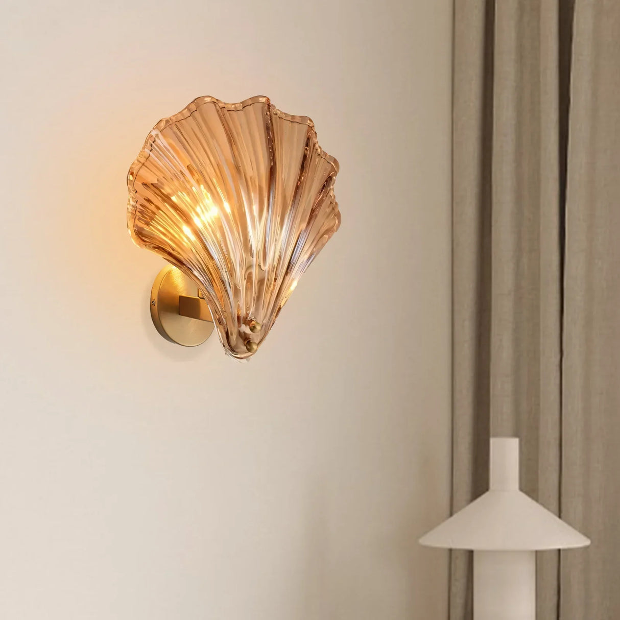Detail of the polished brass base where the glass shell shade attaches