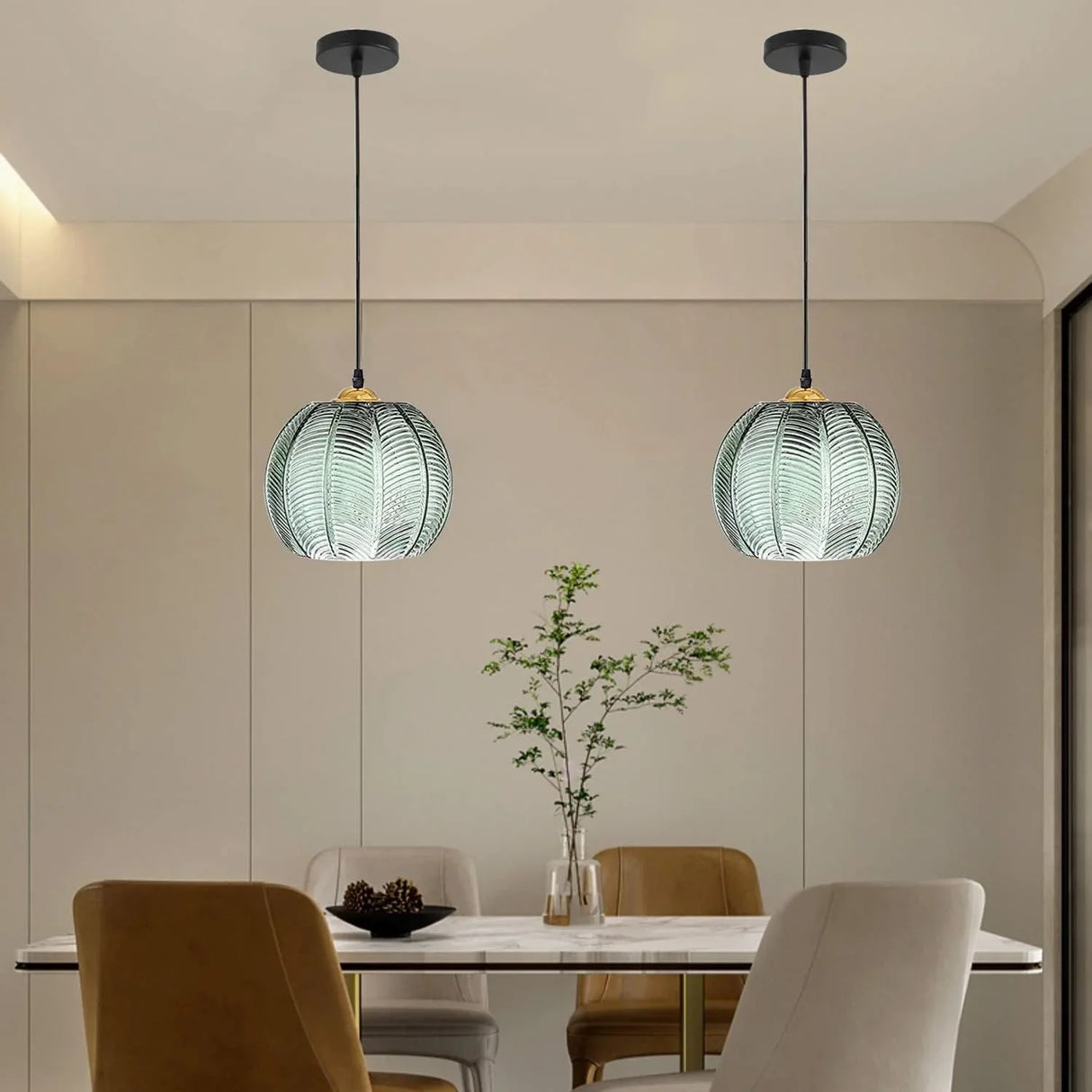 Two green glass globe pendants in different sizes hanging over a living room seating area