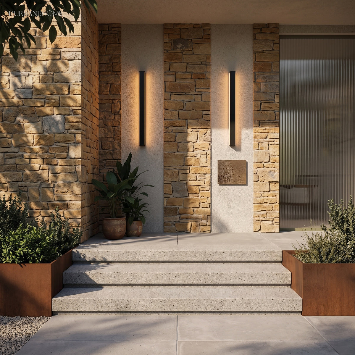 Two linear wall lights on stone and render beside a lit entrance stairway