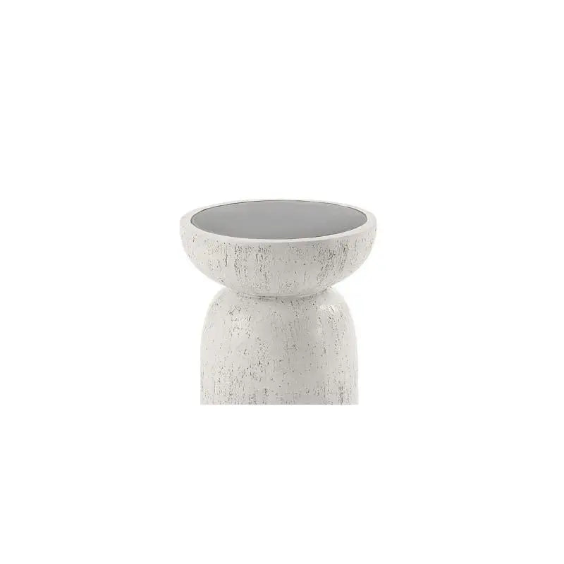 Small marble side table styled beside sofa with décor