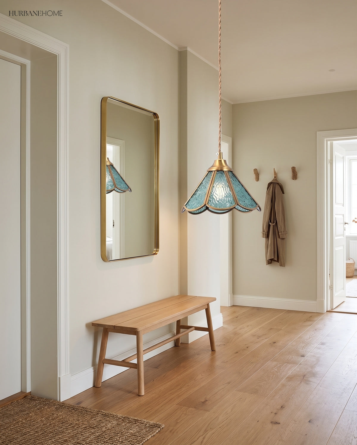 Two small glass pendants hung along a pale hallway above a timber bench
