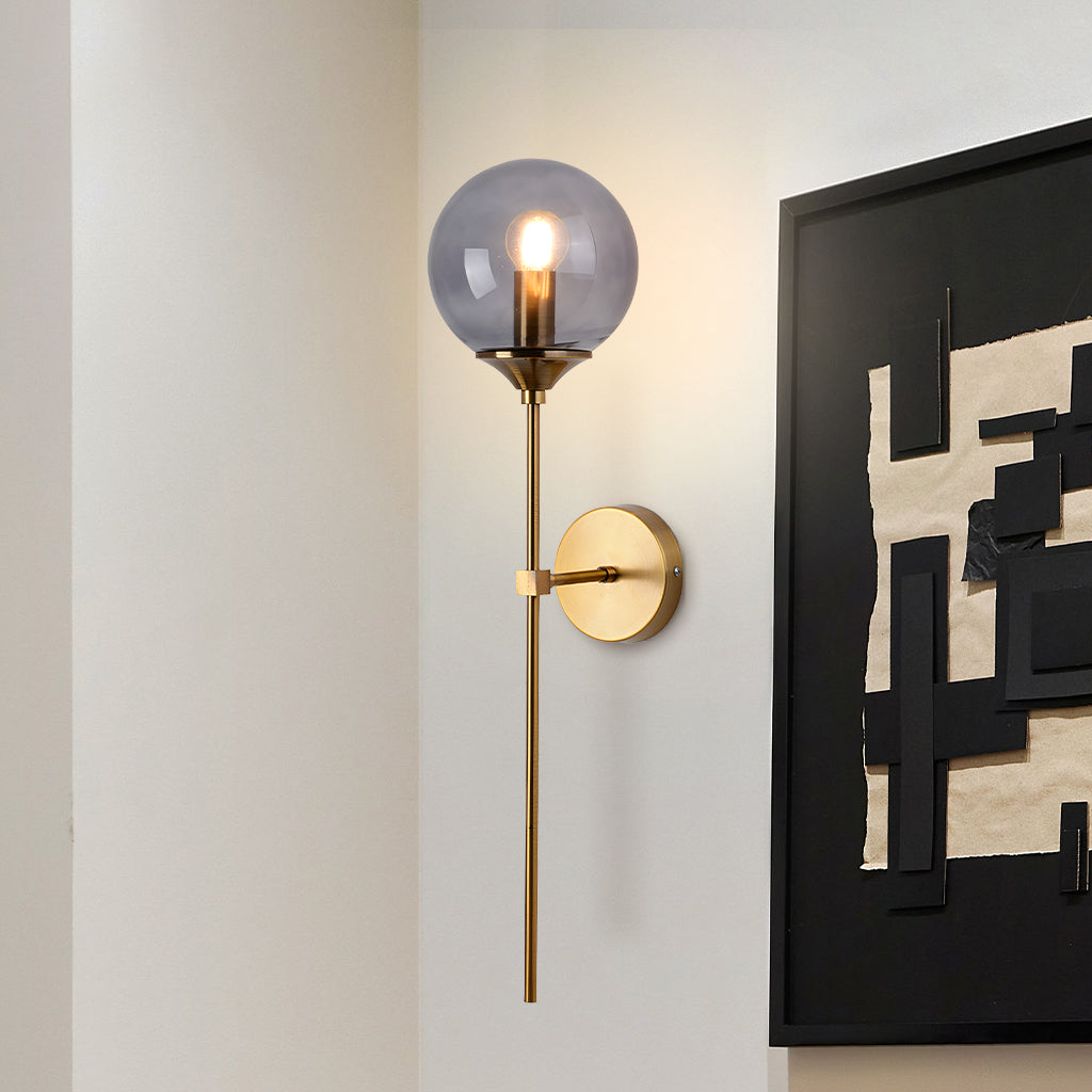 Smoke grey glass globe wall sconce close view on brass