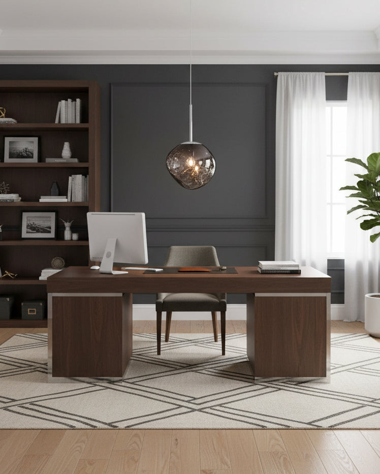 Smoky grey molten pendant hanging above a desk in a dark panelled home office