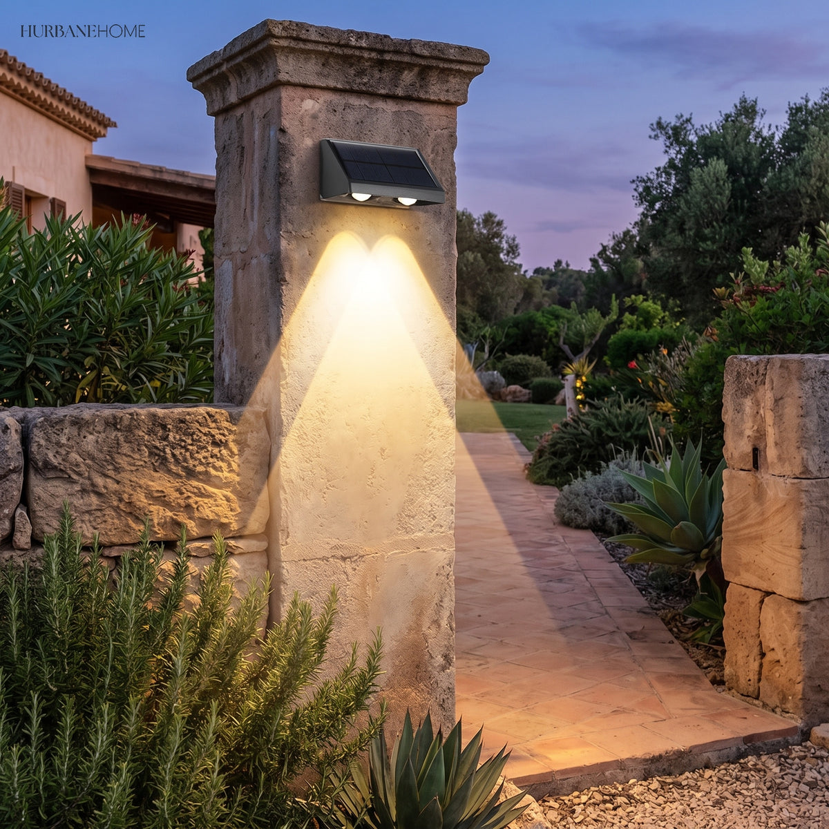 Solar up and down lights flanking a garden gateway and planting