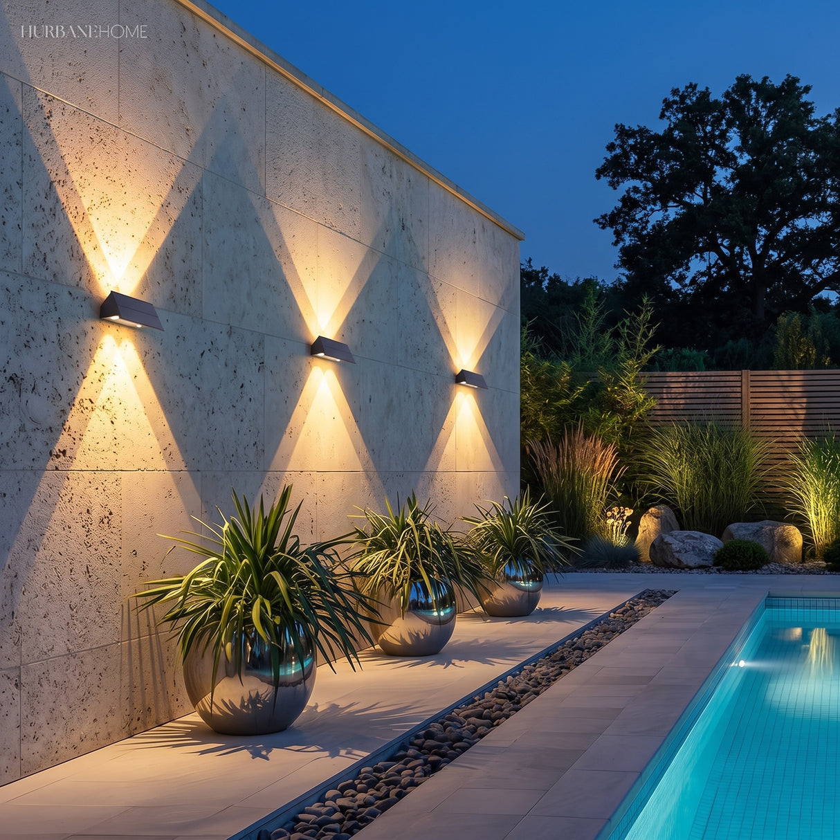Solar wall light mounted on a pillar beside a dark timber fence