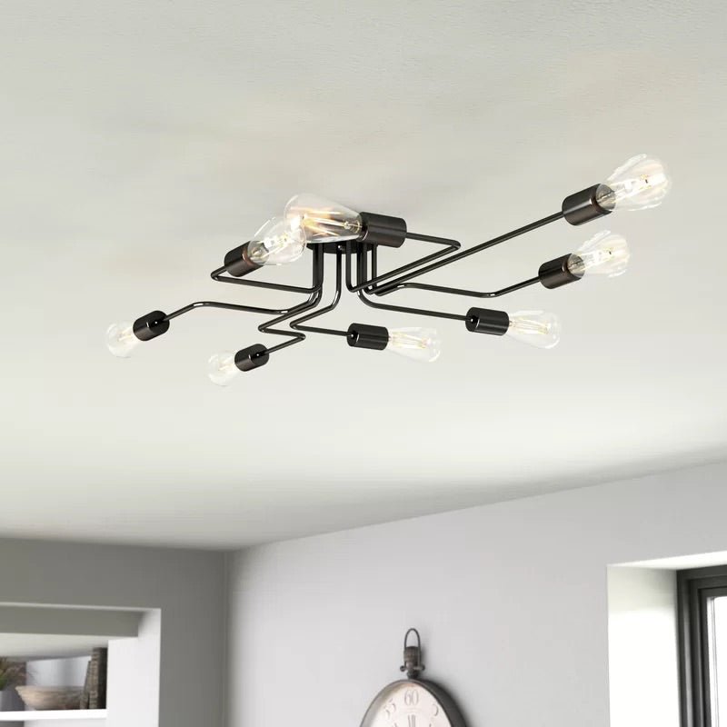 Black sputnik chandelier with bare bulbs seen against a white ceiling