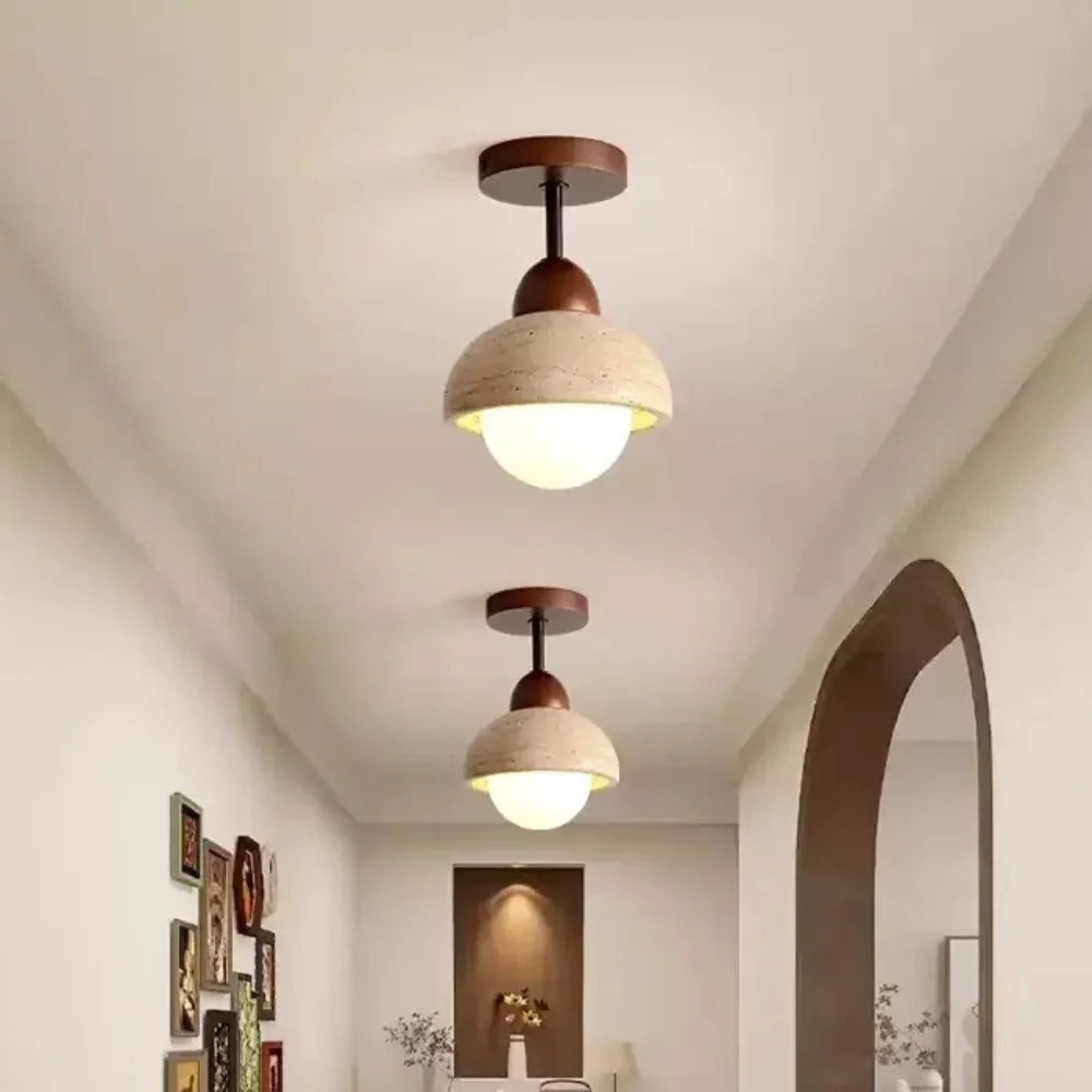 Stone ceiling light with opal glass globe glowing warm