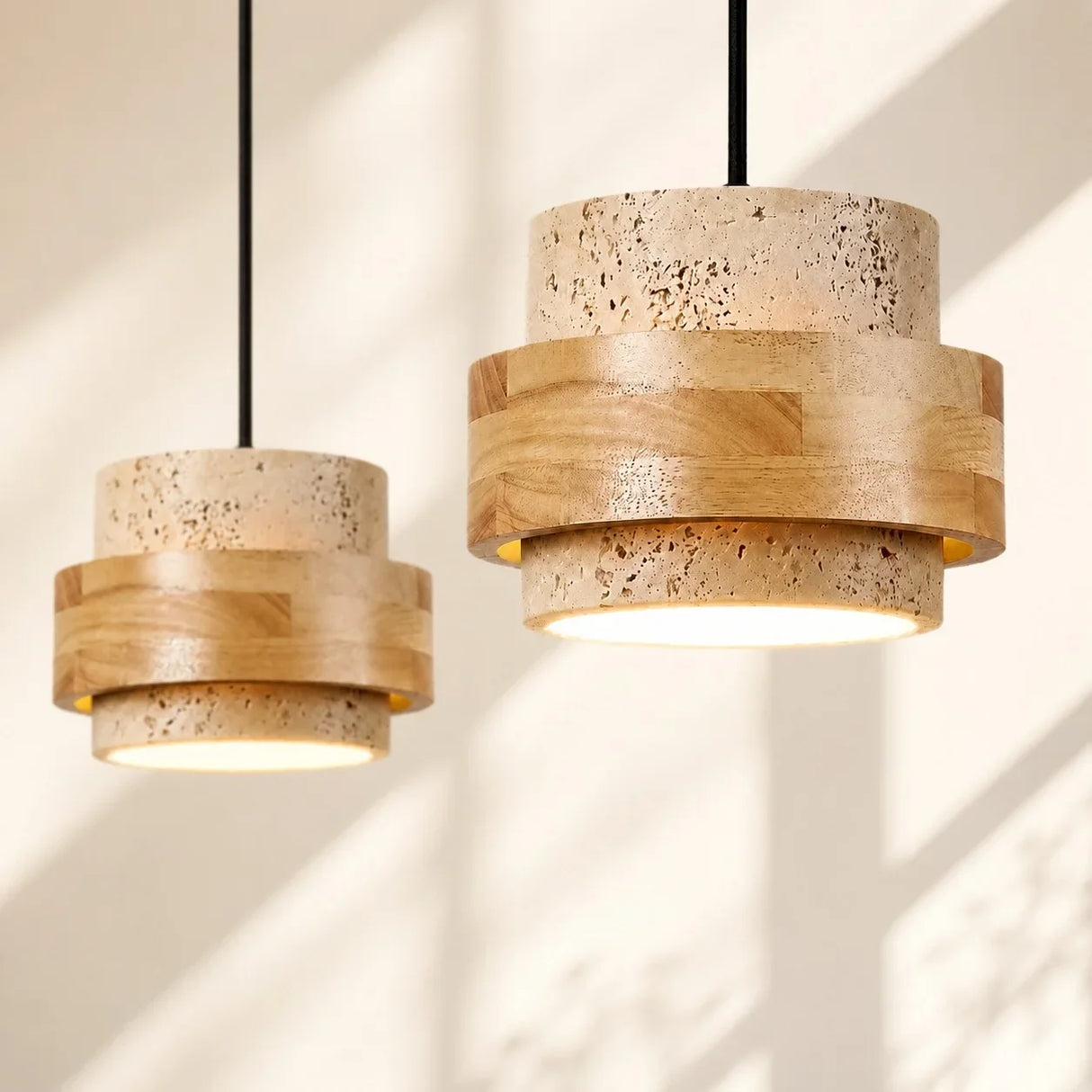 Natural travertine cylinder shades with light wood band, studio close-up