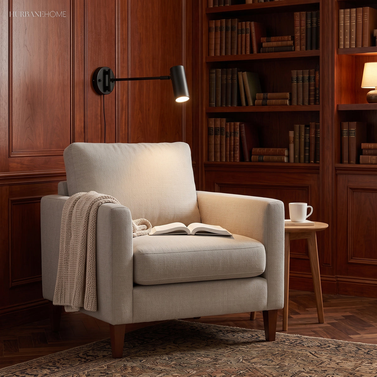 Black swing arm sconce lit over an armchair in a panelled library