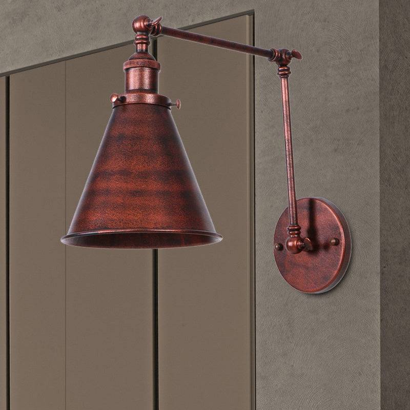 Rust swing arm sconce cut out against a grey studio background