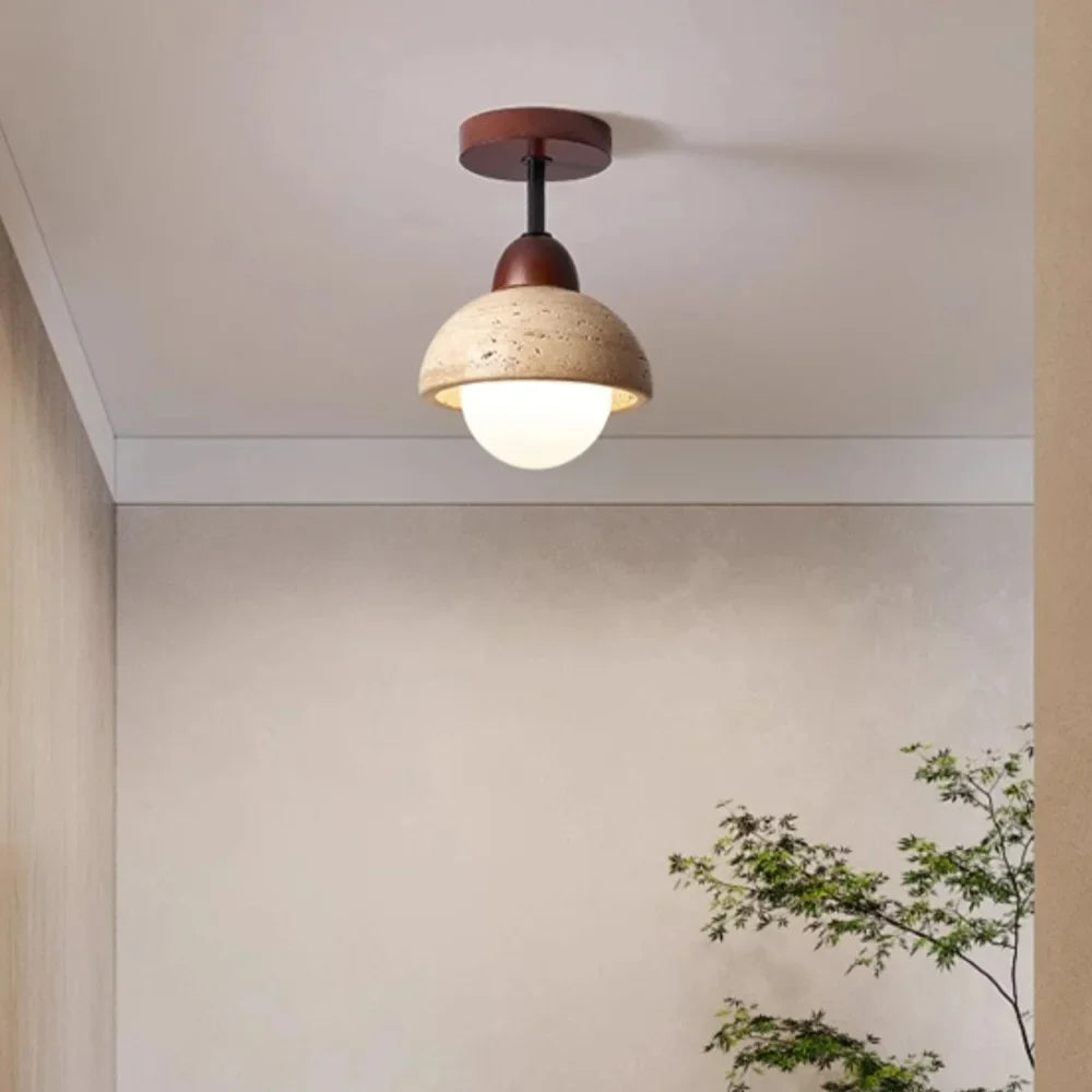 Travertine dome ceiling light lit against a ceiling