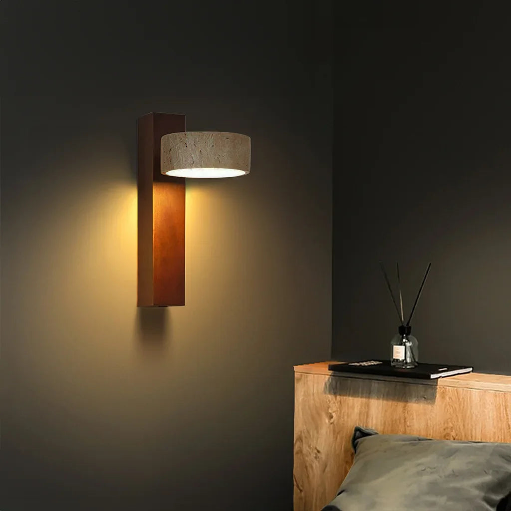 Travertine wall sconce set to cast a warm ambient glow in a styled room