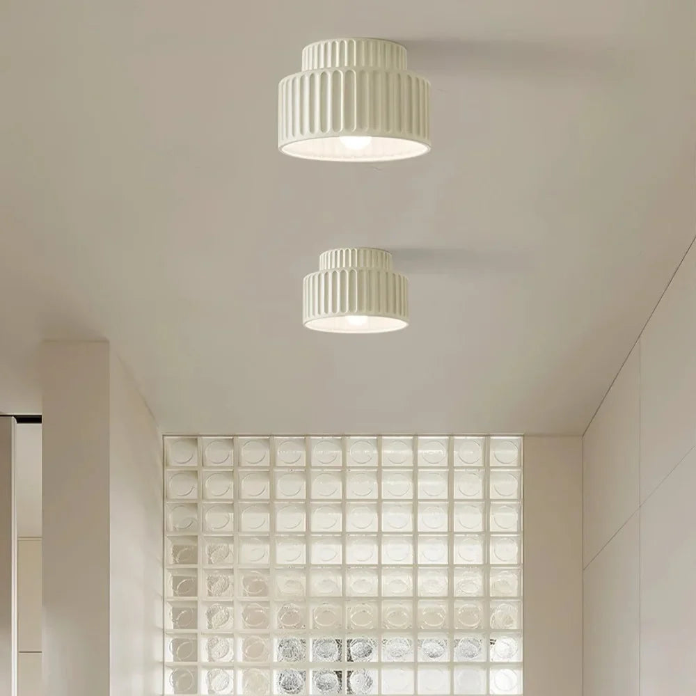 Two-tier semi flush ceiling light shown at a three-quarter angle on a plain backdrop
