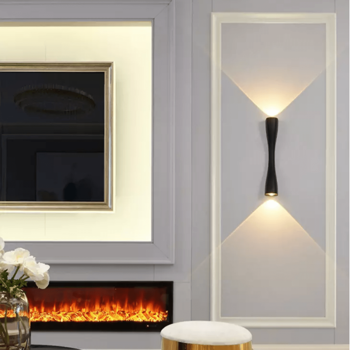 White slim wall light lit on a panelled wall beside a fireplace