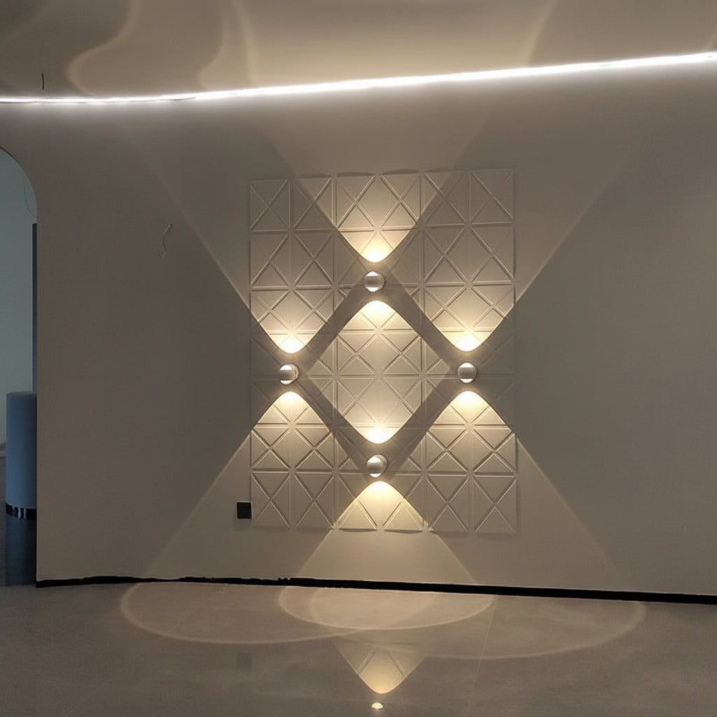 Four white orb sconces lit in a diamond pattern along a corridor wall