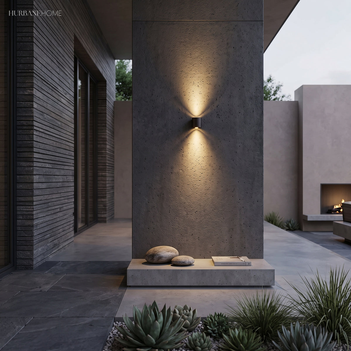 Dark up and down light throwing narrow beams on a concrete column at night