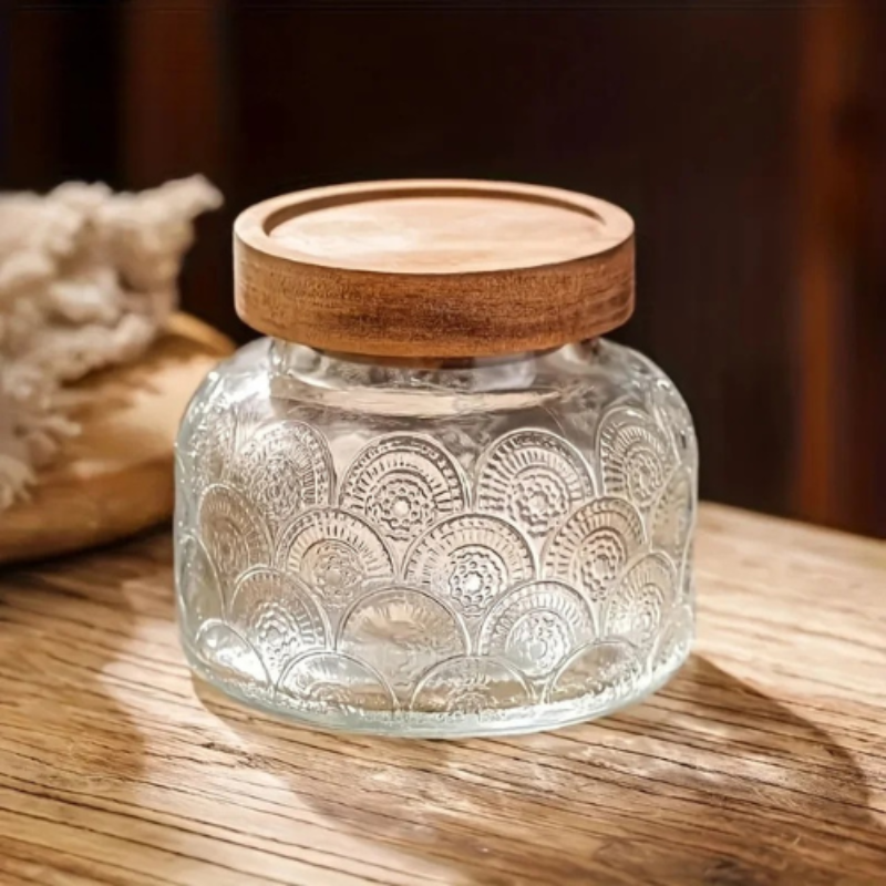 glass storage jars with lids used for food storage on a kitchen table