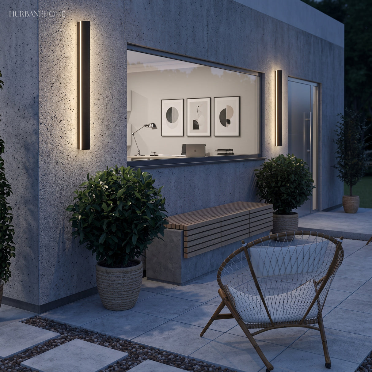 Linear LED wall lights on a concrete facade above a garden bench