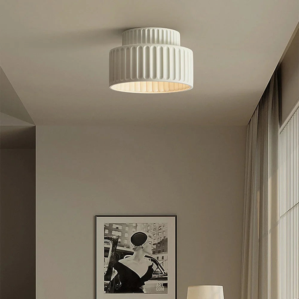 Vintage semi flush ceiling light shown from a low angle against a light backdrop