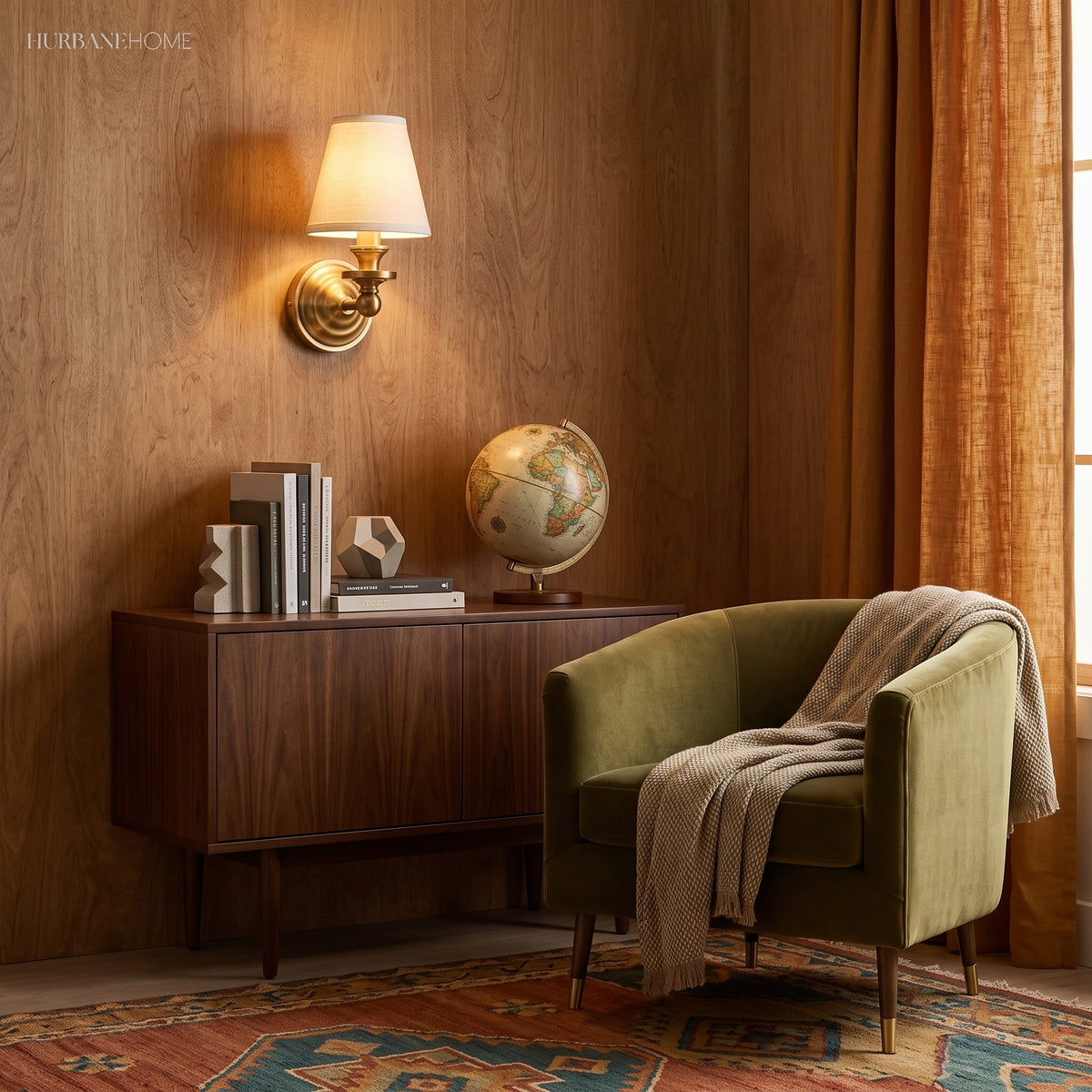 Brass sconce with linen shade lit against a deep blue wall