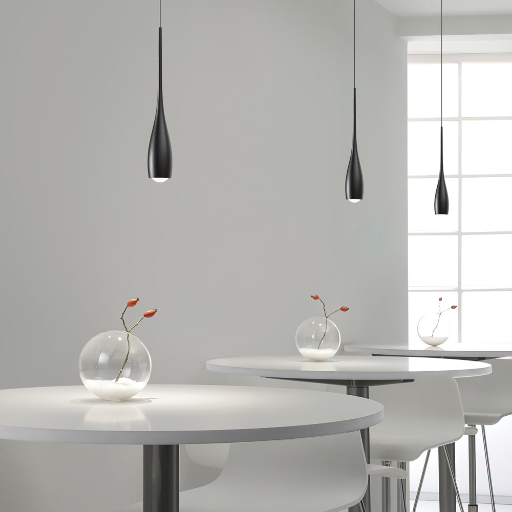 Teardrop pendant light casting soft warm light in a modern room