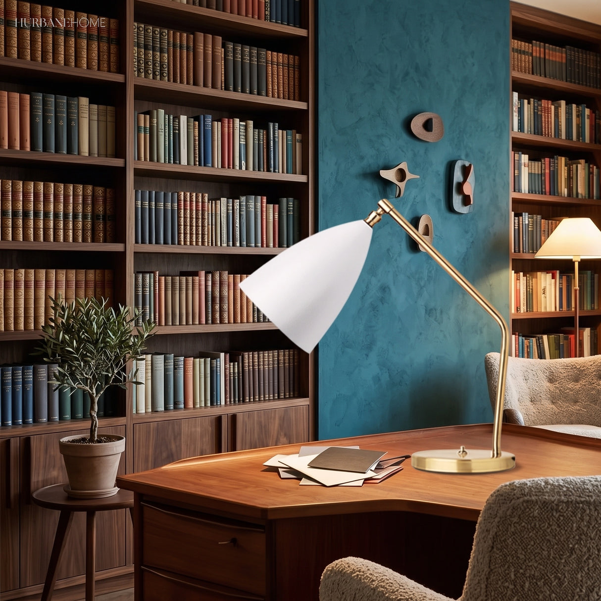 White and brass table lamp on a console with books and stationery