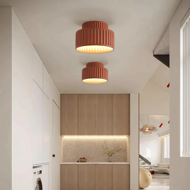 White fluted semi flush mount ceiling light on a plain studio background