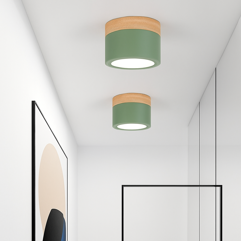 Two green ceiling lights lit on a white hallway ceiling