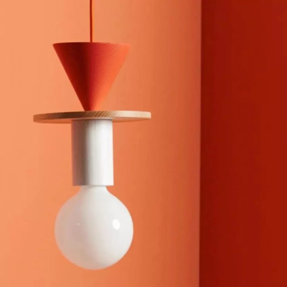 Ash wood geometric pendant light casting warm light in a relaxed lounge