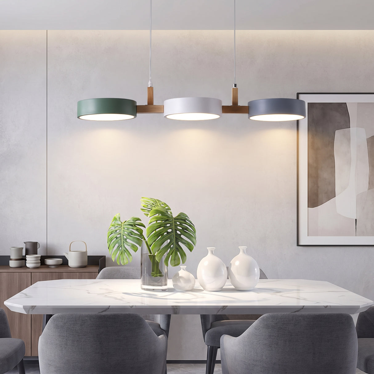 Three drum shades on a wood bar lighting a white marble dining table