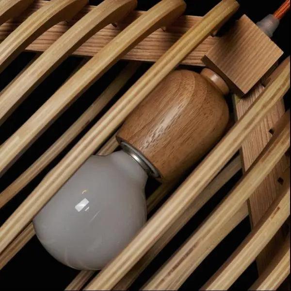 Close view of the bulb and wood lamp holder inside the shade