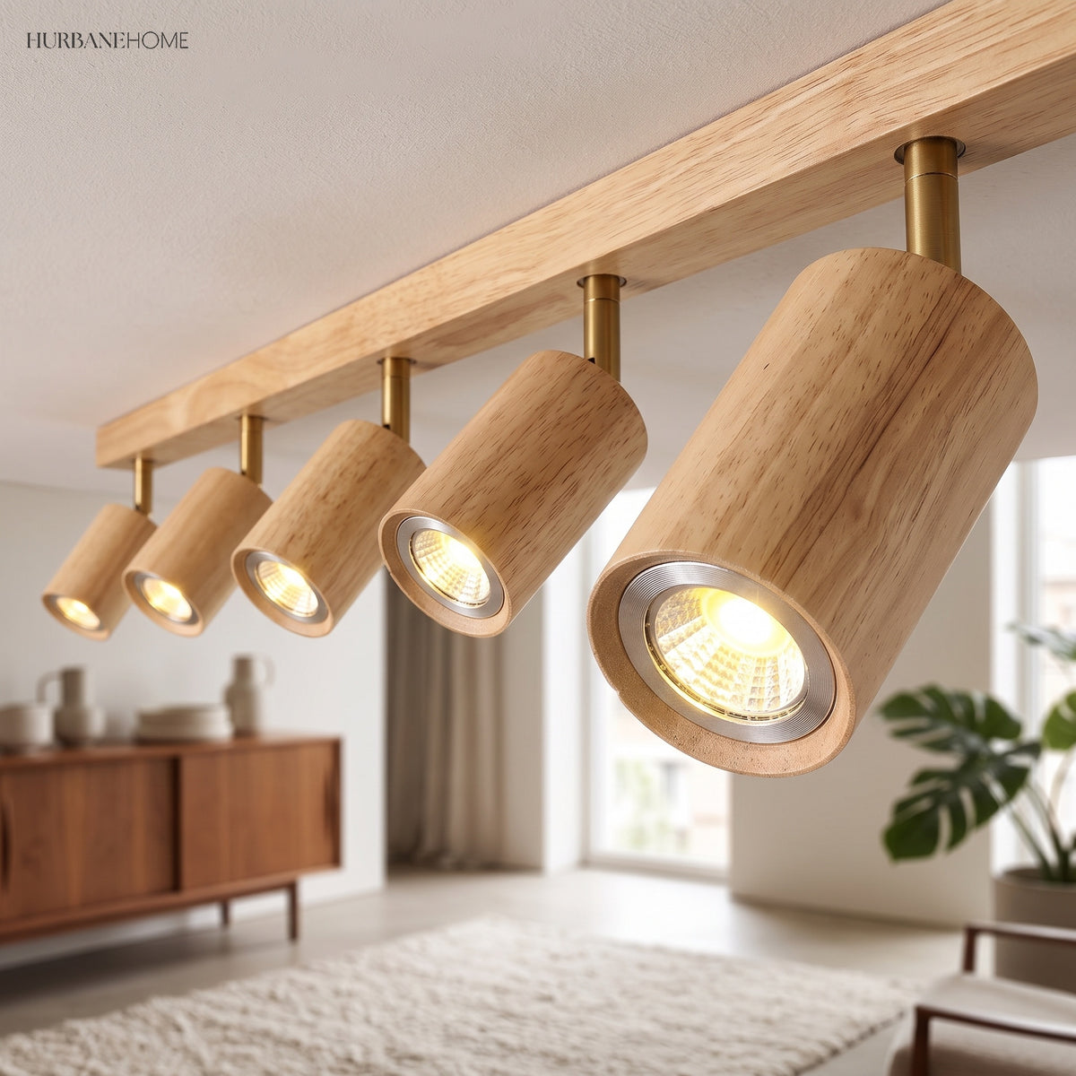 Close view of cylindrical wood spotlight heads angled along the track bar