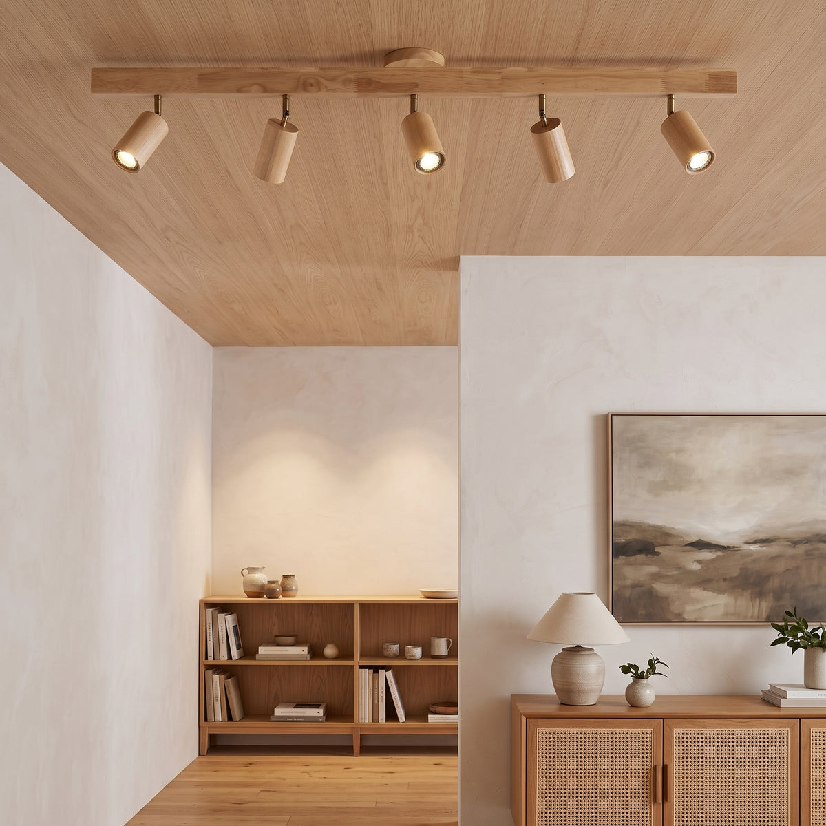Natural oak track lighting bar with five adjustable spotlight heads on a ceiling