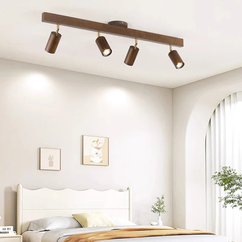 Walnut track bar on a bedroom ceiling above a white bed frame