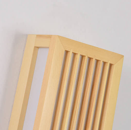 Close-up of the wood frame corner joinery and vertical slats on the sconce