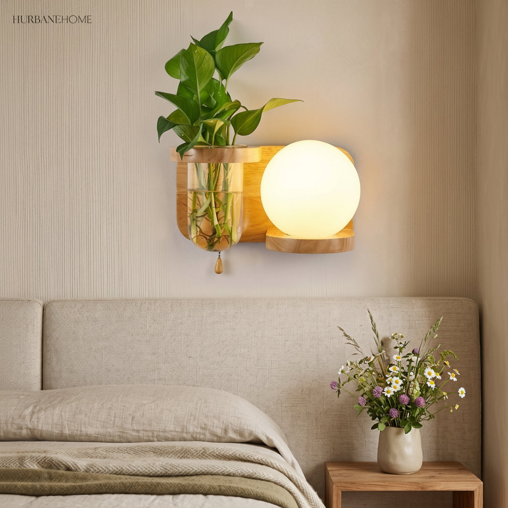 Wood planter sconce lit above a bed with a linen throw