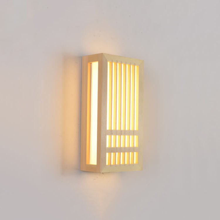 Small wood wall sconce lit at an angle showing its depth and side light