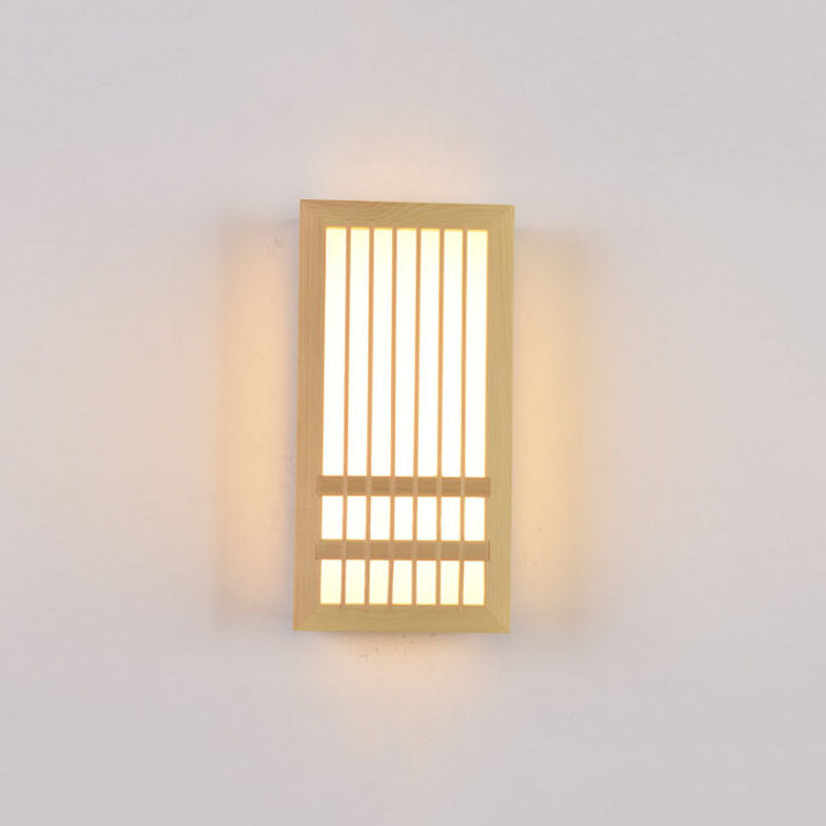 Small wood wall sconce lit straight on with a warm even glow