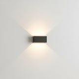 Two grey wall sconces flanking an interior doorway with soft light