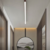 Walnut linear LED flush mount light against a curtained bedroom ceiling